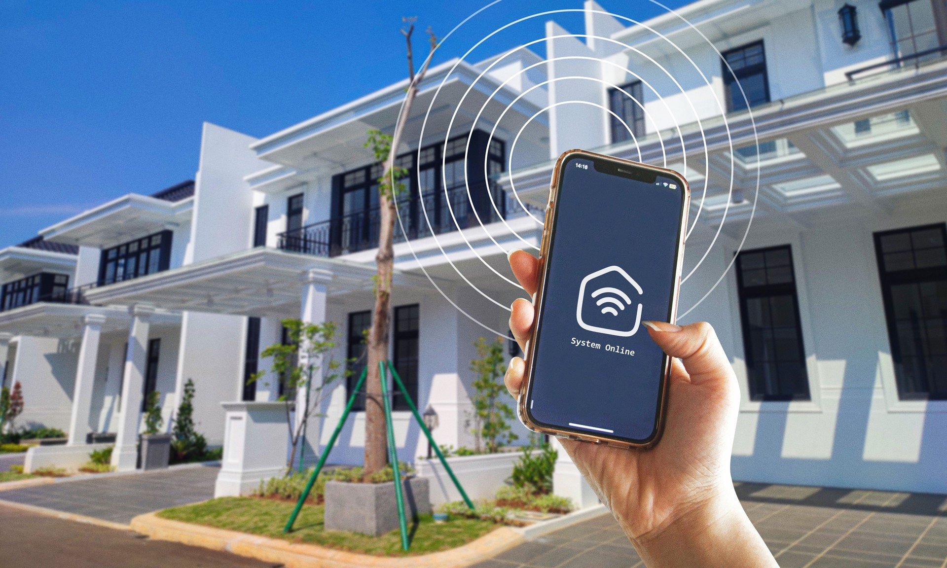 Hand holding phone with smart home app, activating wifi connection from outside of the house